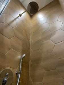 a shower with a tiled wall in a bathroom at Solunska Stylish Apartment in Sofia +11 photos