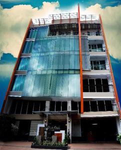 a tall building with a lot of windows at Silver Oaks Suites & Hotel in Manila