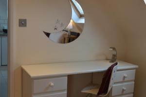 a bathroom with a dressing table with a mirror at The Well Room in Box