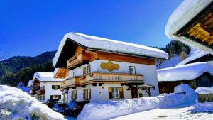 a building covered in snow with snow covered roofs at Appartement Ingrid in Ellmau