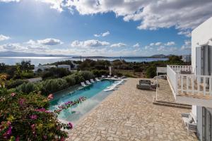 a swimming pool with chairs and a view of the water at Villa Veni in Santa Maria