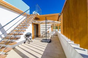 a patio with stairs and a table and chairs at Apartment Lula in Orasac