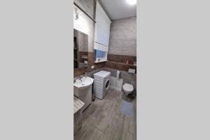 a bathroom with a toilet and a sink at Apartamenty Cieplicka 20a in Jelenia Góra