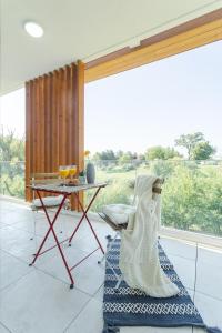sala de estar con mesa y ventana en Il Lago - Azur - Cozy Luxurious Smart Home By The Lake, en Voluntari