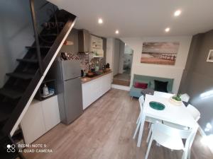 a kitchen and dining room with a white table and chairs at SISTO 85 - HOLIDAY HOUSE in Catania