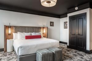 A bed or beds in a room at Bottleworks Hotel