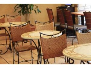 a group of tables and chairs in a restaurant at R&B Hotel Shin Yokohama Ekimae - Vacation STAY 14694v in Yokohama +15 photos