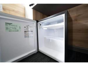 a refrigerator with its door open in a room at R&B Hotel Nagoya Shinkansenguchi - Vacation STAY 15002v in Nagoya