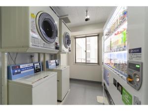 a laundry room with a washer and dryer in a store at R&B Hotel Hakata Ekimae 2 - Vacation STAY 16429v in Fukuoka