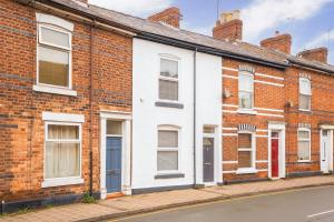 a row of brick houses on a street at South View - 3 bed modern Chester house - Close to city centre in Chester
