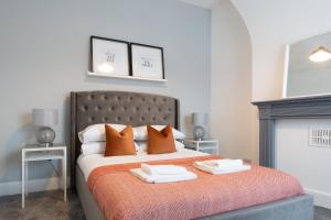 a bedroom with a bed with two towels on it at South View - 3 bed modern Chester house - Close to city centre in Chester