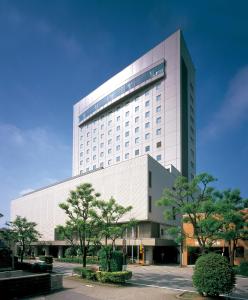 a large building with a large clock on it at Hotel New Otani Takaoka in Takaoka
