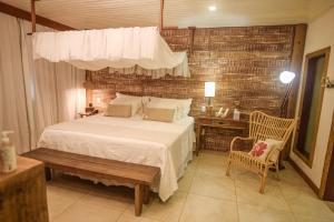 Ένα ή περισσότερα κρεβάτια σε δωμάτιο στο Ecocharme Pousada do Marcilio