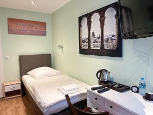 a bedroom with a bed and a desk with a coffee maker at Glashütten Hotel in Glashütten