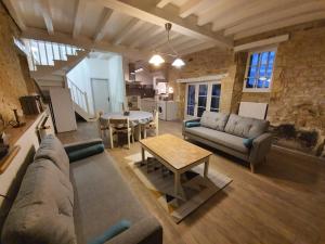 a living room with a couch and a table at Domaine de Bagnegrole in Saint-Cyprien