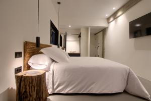 A bed or beds in a room at AFTER Hotel