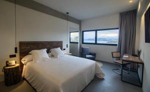A bed or beds in a room at AFTER Hotel