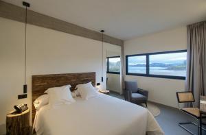 A bed or beds in a room at AFTER Hotel