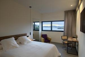 A bed or beds in a room at AFTER Hotel