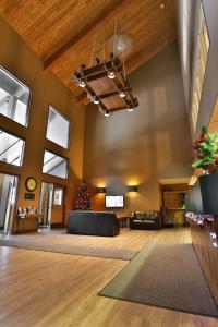 a large lobby with a christmas tree in the center at Griz Inn by FantasticStay in Fernie