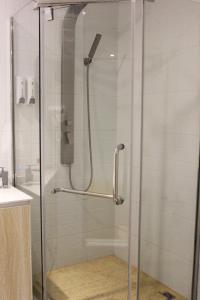 a shower with a glass door in a bathroom at 7Days Inn Chongqing Longtou Temple North Train Station North Plaza Branch in Chongqing