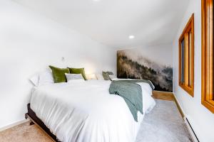 a bedroom with a large white bed and a window at Owen D in Jackson