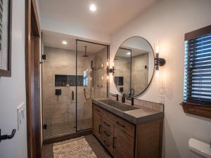 a bathroom with a sink and a shower with a mirror at Beautiful Views! Jacuzzi, Indoor/ Outdoor Fireplace, Steps to Lake Estes in Estes Park +46 photos