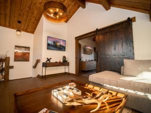 a living room with a couch and a table at Beautiful Views! Jacuzzi, Indoor/ Outdoor Fireplace, Steps to Lake Estes in Estes Park