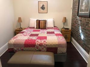 a bedroom with a bed with a quilt on it at The Courtyards in New Orleans