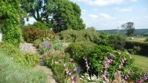 a garden with lots of flowers and bushes at Shallowdale House in Helmsley