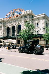 a black car parked in front of a building at The Crawford Hotel in Denver