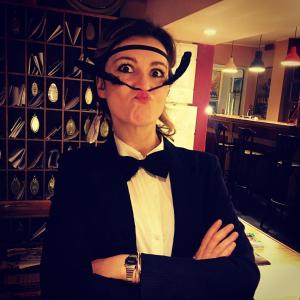 a woman in a tuxedo with a bow tie at Hotel Sirenetta in Lido di Ostia
