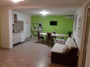 a living room with a couch and a table and a kitchen at apartman in Čačak