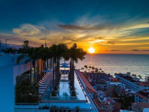 a view of a sunset from a balcony of a resort at PIER 57 - 609 2 BR Amazing Roof in Romantic Zone in Puerto Vallarta +61 photos