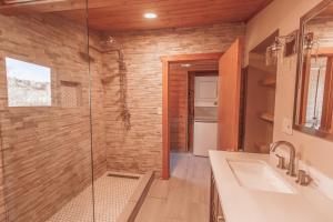 a bathroom with a glass shower and a sink at Erik's Ranch in Livingston