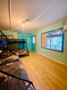 a room with two bunk beds and a window at Pether Cottage - Talbingo NSW in Talbingo