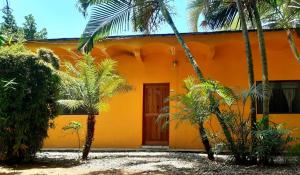 a orange house with palm trees in front of it at Casa Bamboo San Pancho in San Francisco