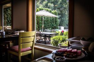 a window in a room with a table and chairs and an umbrella at All Seasons Bed & Breakfast in Kelowna