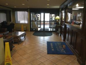 a lobby of a restaurant with a sign on the floor at Baymont by Wyndham Bridgeport/Frankenmuth in Bridgeport