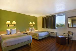 A bed or beds in a room at Motel 6-Cocoa Beach, FL