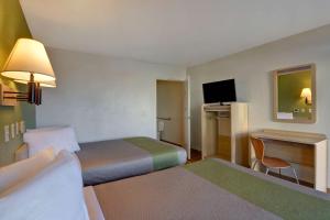 A bed or beds in a room at Motel 6-Cocoa Beach, FL