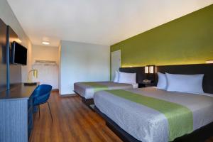 A bed or beds in a room at Motel 6-Cocoa Beach, FL