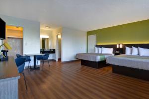 A bed or beds in a room at Motel 6-Cocoa Beach, FL