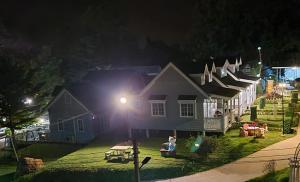 a house with people sitting outside of it at night at Farm Terrace in Kaengsopha