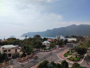 a street in a town with a mountain in the background at Sao Mai hotel in Con Dao