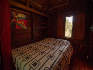 a bedroom with a bed in a room with a window at 2 bedroom cottage, 3 blocks from beach and center of San Juan in San Juan del Sur