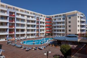 a large apartment building with a swimming pool in front of it at Apartments in Central Plaza in Sunny Beach