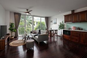 a living room with a couch and a table at Pegasy Premium Suites & Residence Westlake in Hanoi