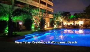 a swimming pool at night with green lights at View Talay Residence 6 Wongamat Beach in Pattaya North