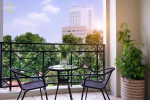 a balcony with a table and chairs and a window at Atlanta Residences in Hanoi